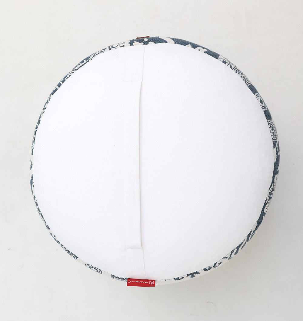 The RAMSHA HOME Boho Printed Round Pouf with Insert PF 176 features a patterned dark blue and white edge, centered seam, small red side tag, and sits on a light surface—an ideal accent for modern home décor.