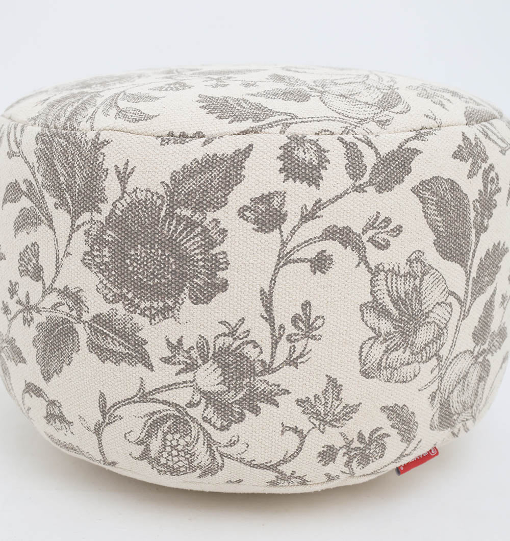The RAMSHA HOME Round Bohemian Printed Pouf with Comfortable Insert PF 177 features a cream fabric, detailed black pattern, and small red tag. Lightweight and stylish, it adds decorative seating and comfort to any space.