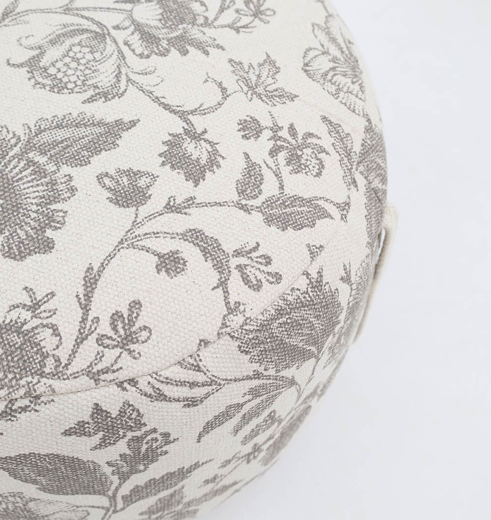 The RAMSHA HOME Round Bohemian Printed Pouf with Comfortable Insert PF 177 features a beige base with gray floral designs, shown from an angled top view—ideal as decorative seating with lightweight thermocol support.