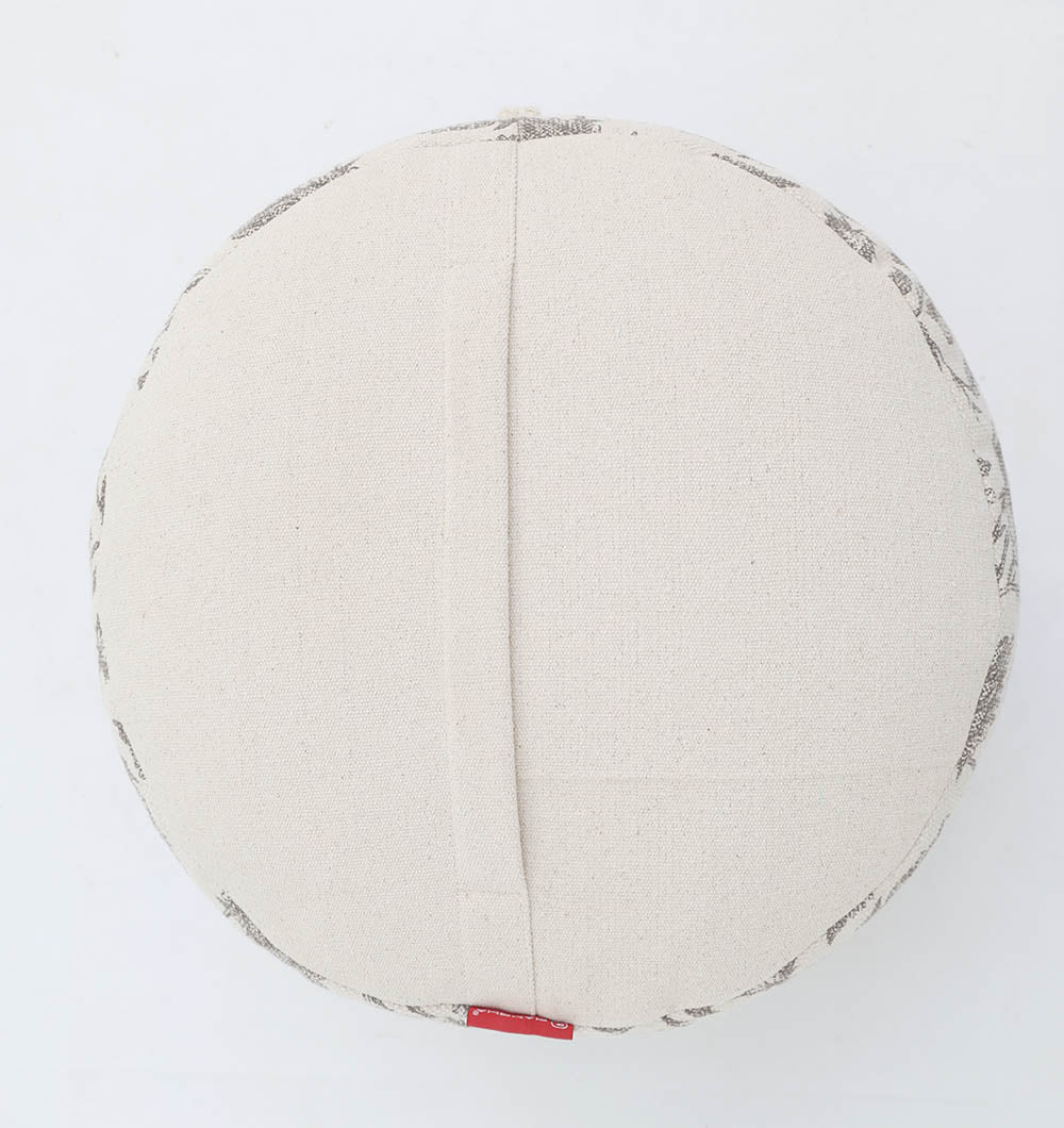 The RAMSHA HOME Round Bohemian Printed Pouf with Comfortable Insert PF 177 features a stylish beige design, center seam, and red tag. Ideal as decorative seating, this pouf adds both comfort and charm to any space. Shown on a white background.