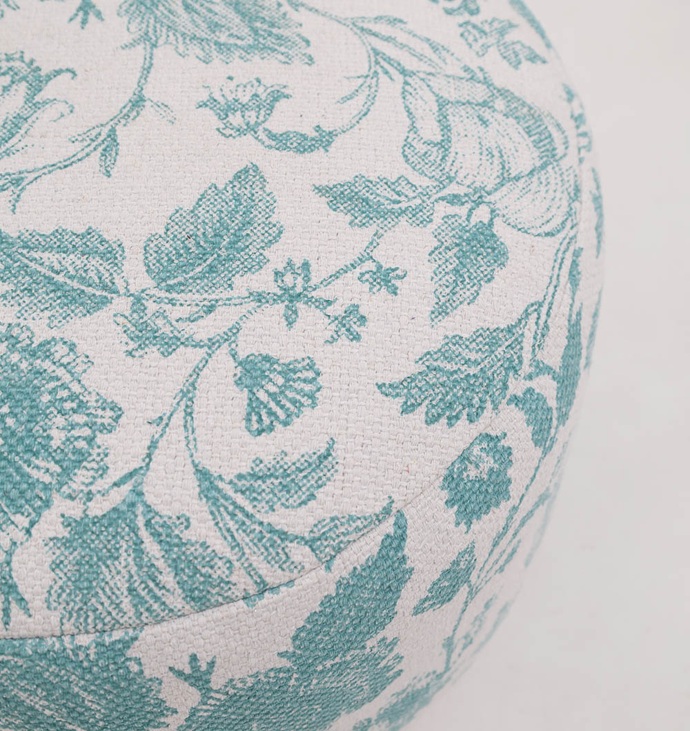 A close-up of the RAMSHA HOME Round Bohemian Printed Pouf with Comfortable Insert PF 177 displays its teal floral pattern on an off-white background, woven texture, and detailed design, making this stylish pouf inviting for any space.