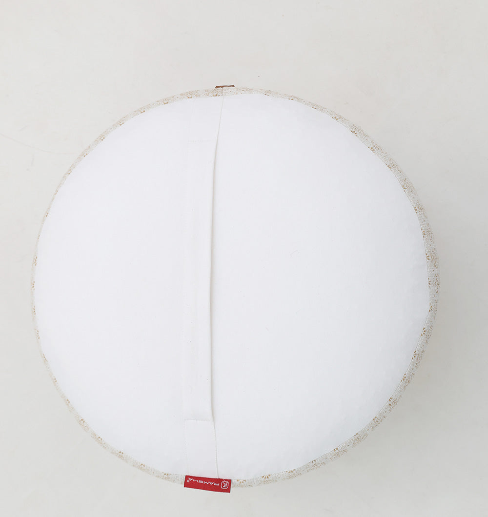 The RAMSHA HOME Round Bohemian Printed Pouf with Comfortable Insert PF 180 features a soft, textured edge, fabric handle, and red tag—an elegant accent and a subtle alternative to classic floral poufs for versatile home décor.