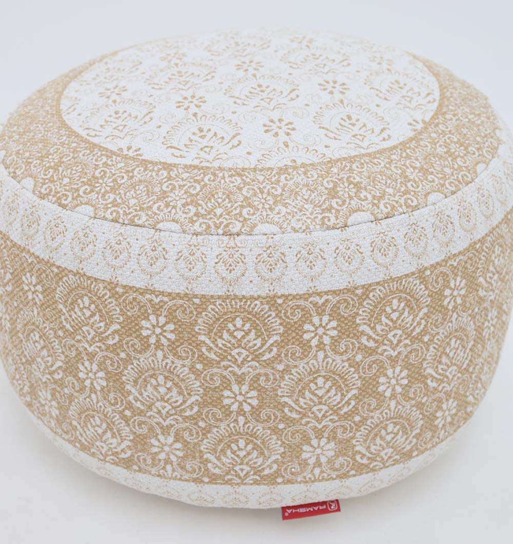 The RAMSHA HOME Round Bohemian Printed Pouf with Comfortable Insert PF 180 features elegant beige and white floral patterns, a distinct red fabric tag at the base, and is perfect for enhancing your home décor. Displayed on a plain white background.