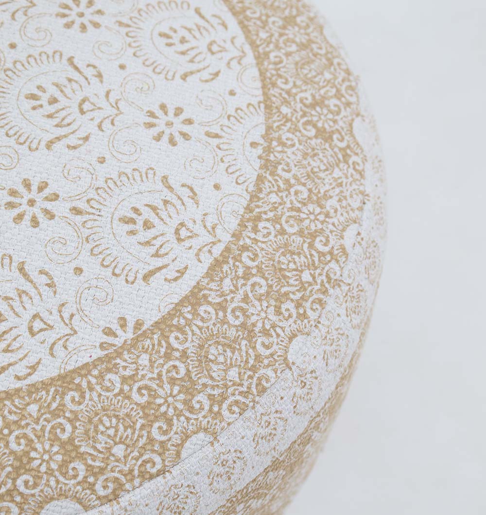 A close-up of the RAMSHA HOME Round Bohemian Printed Pouf with Comfortable Insert PF 180, showcasing intricate tan and white patterns on textured fabric—an ideal accent piece to enhance your home décor.