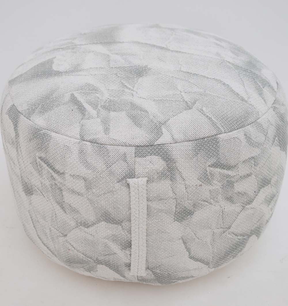 The RAMSHA HOME Round Bohemian Printed Pouf with Comfortable Insert PF 182 features a light gray, textured abstract pattern and side fabric handle, making it a stylish addition to your home décor against a plain white background.