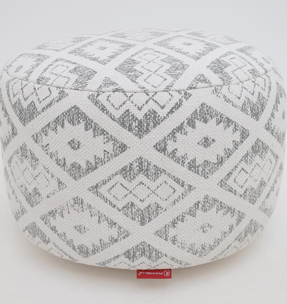 The RAMSHA HOME Round Bohemian Printed Pouf with Comfortable Insert PF 183 features a stylish white and gray geometric diamond design, textured fabric with a small red tag, and is perfect for enhancing your décor. Background is plain white.