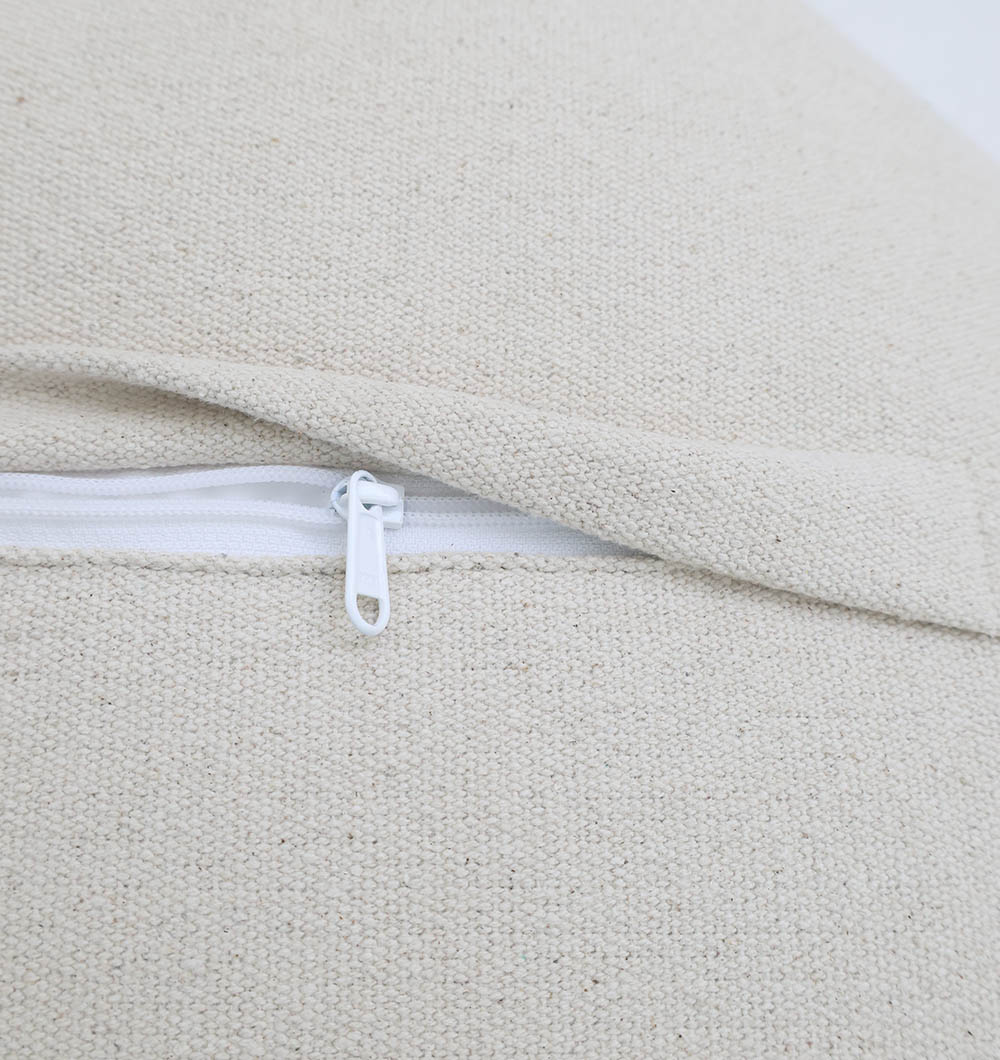 Close-up of a white zipper partially open on textured, off-white fabric, part of the RAMSHA HOME Luxury Round Floor Pouf with Leather Handle PF 190.