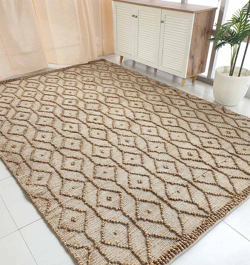 The RAMSHA HOME Brown Rectangle Area Rug and Carpet SR-004 features a geometric diamond pattern and durable construction, and is shown on a white tiled floor near a cabinet, light beige curtains, and a potted plant by the window.
