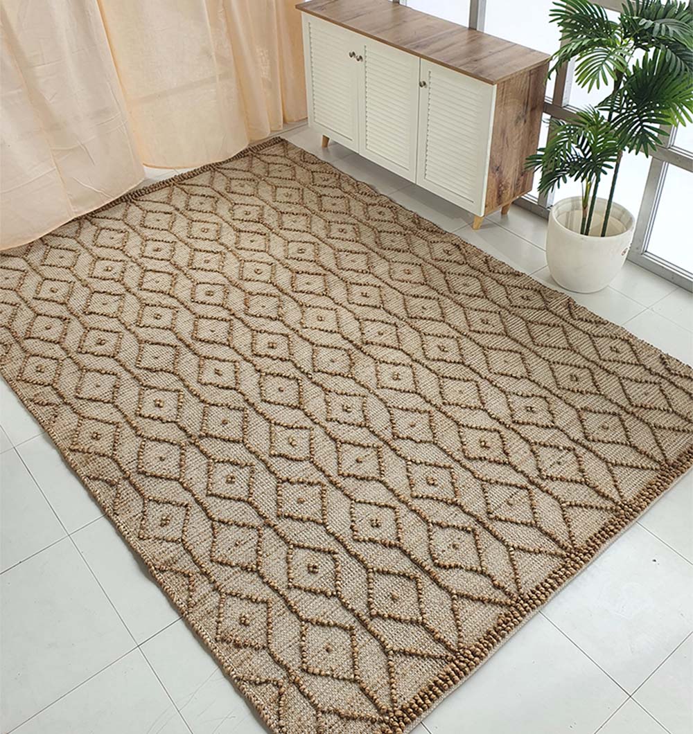 The RAMSHA HOME Brown Rectangle Area Rug and Carpet for Stylish Living Room SR-004 features a geometric diamond pattern and durable construction, displayed on a white tiled floor near a wooden cabinet, potted plant, and large windows.