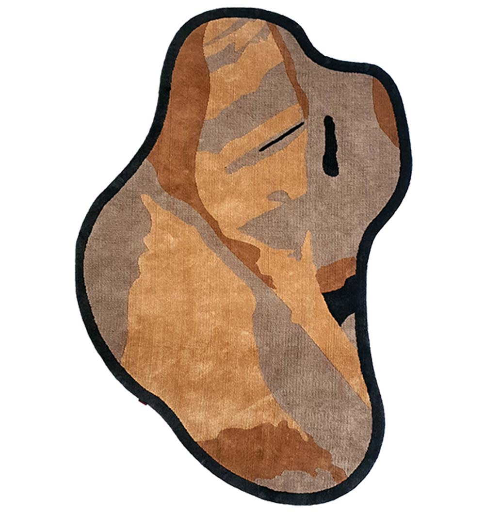 The RAMSHA HOME Curved Shaped Multi Colored Carpet CMN-03 features an abstract design in earthy brown, tan, and beige tones with a stylized human face, minimal black line details, and a bold black border.