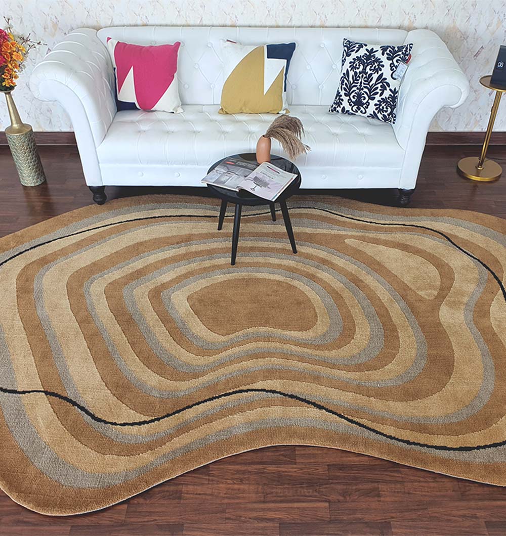 A modern living room featuring a white tufted sofa, colorful geometric pillows, a small round black table with a vase and magazines, and the RAMSHA HOME Curved Shaped Multi Colored Carpet CMN-08 on dark wood flooring.