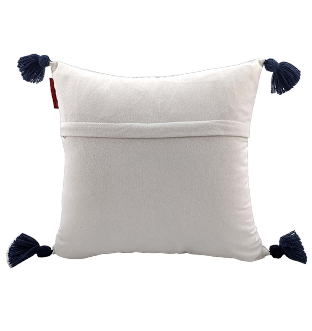 The RAMSHA HOME Embroidery White And Black Cotton Cushion With Tassel (CS-194) features black tassels on each corner and a horizontal flap on the back, displayed against a plain white background.