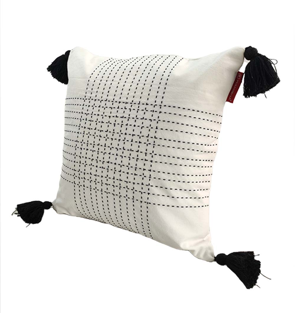 The RAMSHA HOME Embroidery White And Black Cotton Cushion With Tassel CS-192 features black stitched grid patterns and tassels on each corner, shown against a plain white background.