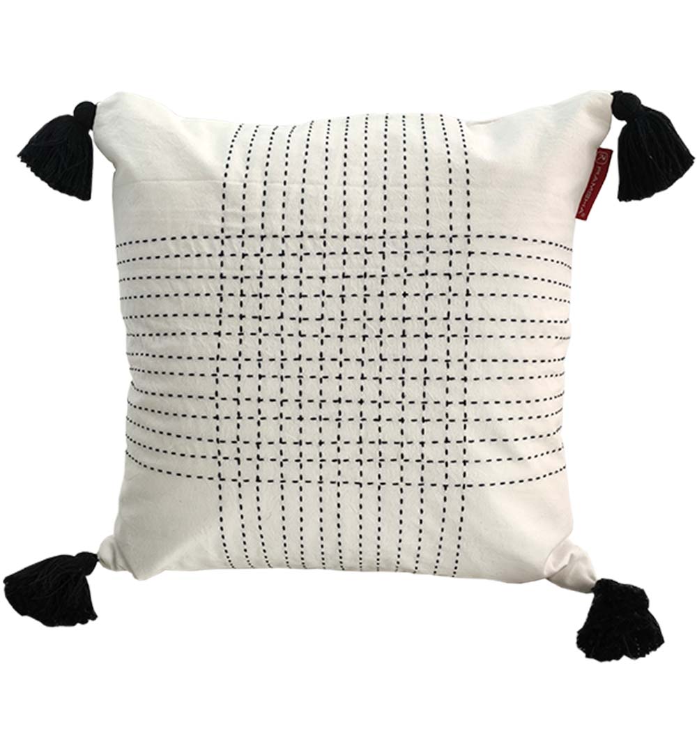 The RAMSHA HOME Embroidery White And Black Cotton Cushion With Tassel CS-192 features a black stitched grid, black tassels on each corner, and adds a stylish touch to your space.