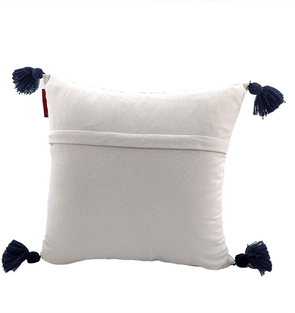RAMSHA HOME’s Embroidery White And Black Cotton Cushion With Tassel CS-192 features black tassels on each corner and a horizontal envelope closure on the back, displayed against a plain white background.