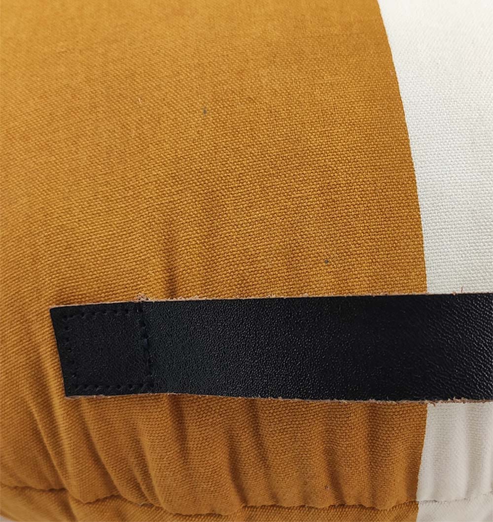 Close-up of the RAMSHA HOME Cotton Cushion CS-224, showing its mustard yellow and white color block design with a stitched black strap on the cotton cushion cover.