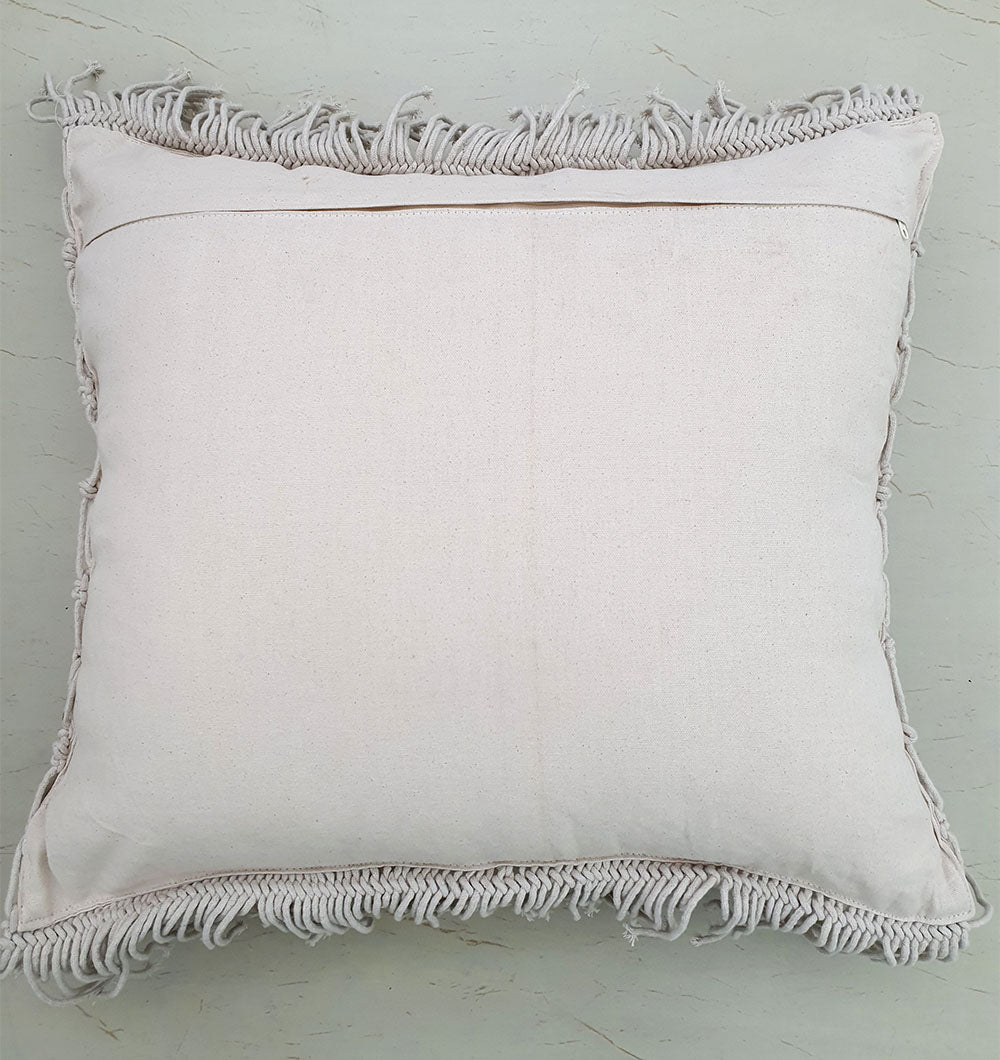 The RAMSHA HOME Cotton Cushion CS-276 features a square, off-white design with fringed edges, ideal for handmade decor accents, and is shown placed on a light-colored surface.