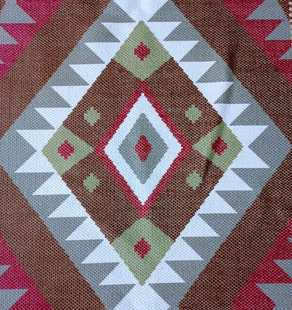 The Tribal Kilim Diamond Multicolor Rug – DD 015 by RAMSHA HOME features a geometric, diamond motif with zigzag and triangle shapes, in brown, white, green, red, and gray, inspired by traditional kilim designs.