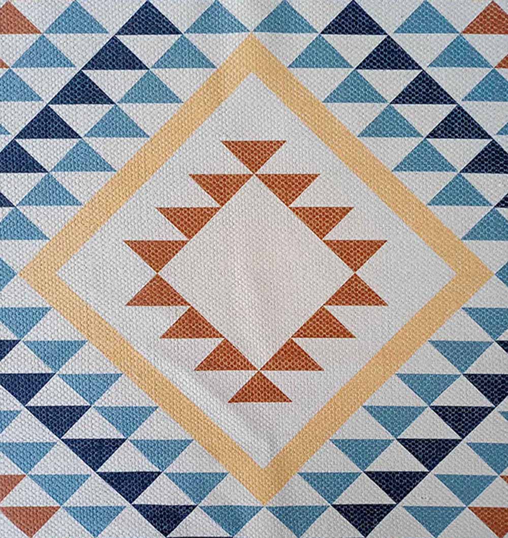 The RAMSHA HOME Geometric Diamond Tribal Blue & Tan Rug – DD 016 features rows of blue, navy, and turquoise triangles with a central diamond in yellow and brown on a textured dhurry fabric.