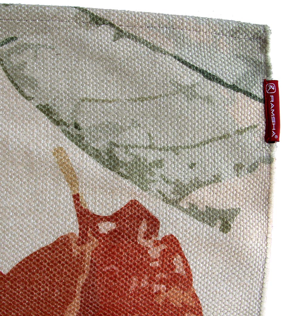 A close-up of the Polyester Printed Rug Multi Color DD-038 by RAMSHA HOME shows textured fabric in green and red abstract patterns. A red tag with "RAMSHA" in white text is sewn onto the edge.