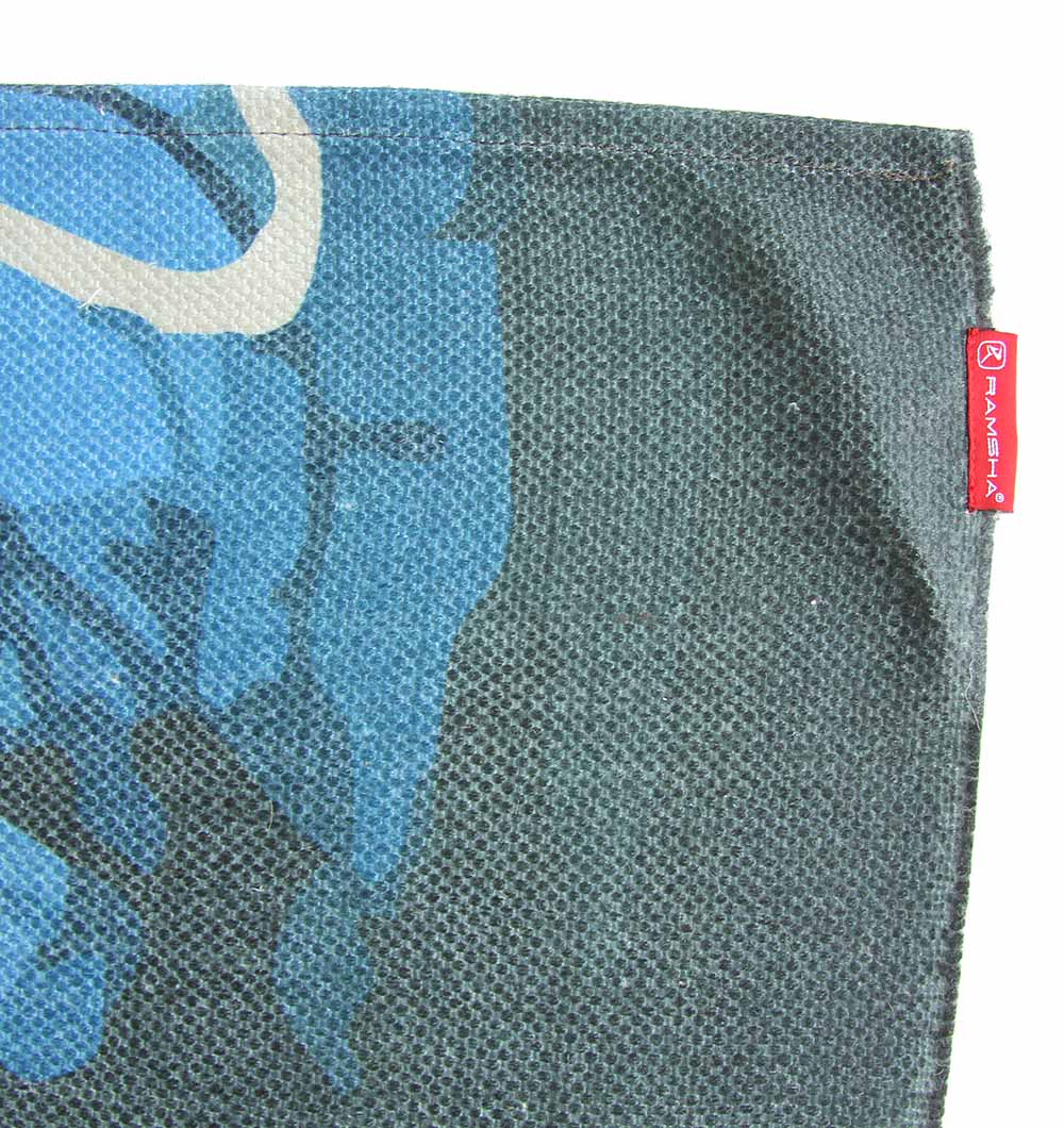 Close-up of the RAMSHA HOME Digital Printed Rug Multi Color DD-039 showing textured blue and dark green abstract patterns. A red fabric tag with white text is sewn into the right edge.