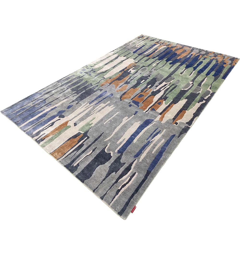 The RAMSHA HOME Decorative Area Carpet Tencil & Cotton Multi Color HKV-09 features a rectangular design with abstract vertical streaks in blue, green, gray, beige, and brown on a light gray background.