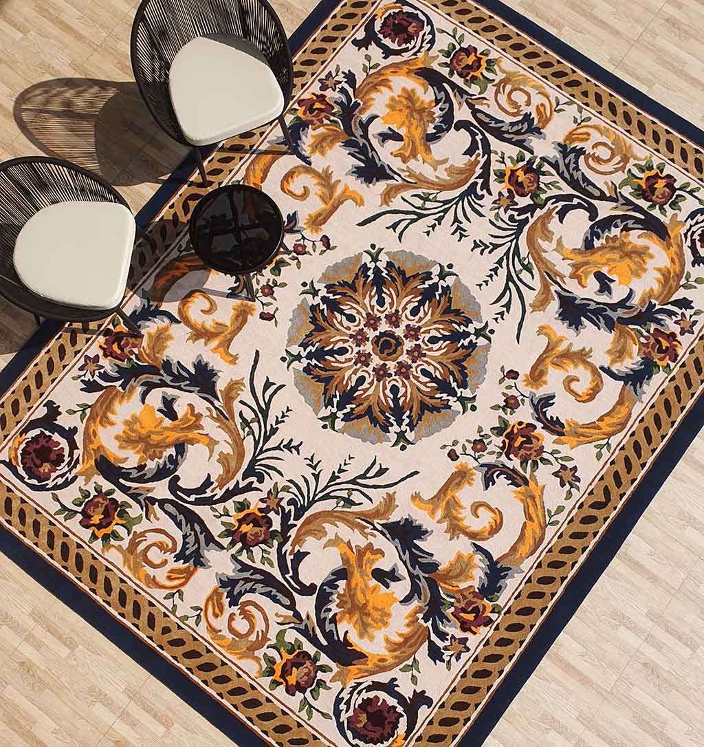 The RAMSHA HOME Polyester & Cotton Hall Decor Rug - HTP 02 (300x400cm) with ornate gold, navy, and burgundy baroque patterns anchors two modern chairs and a small black table on a light wood floor.