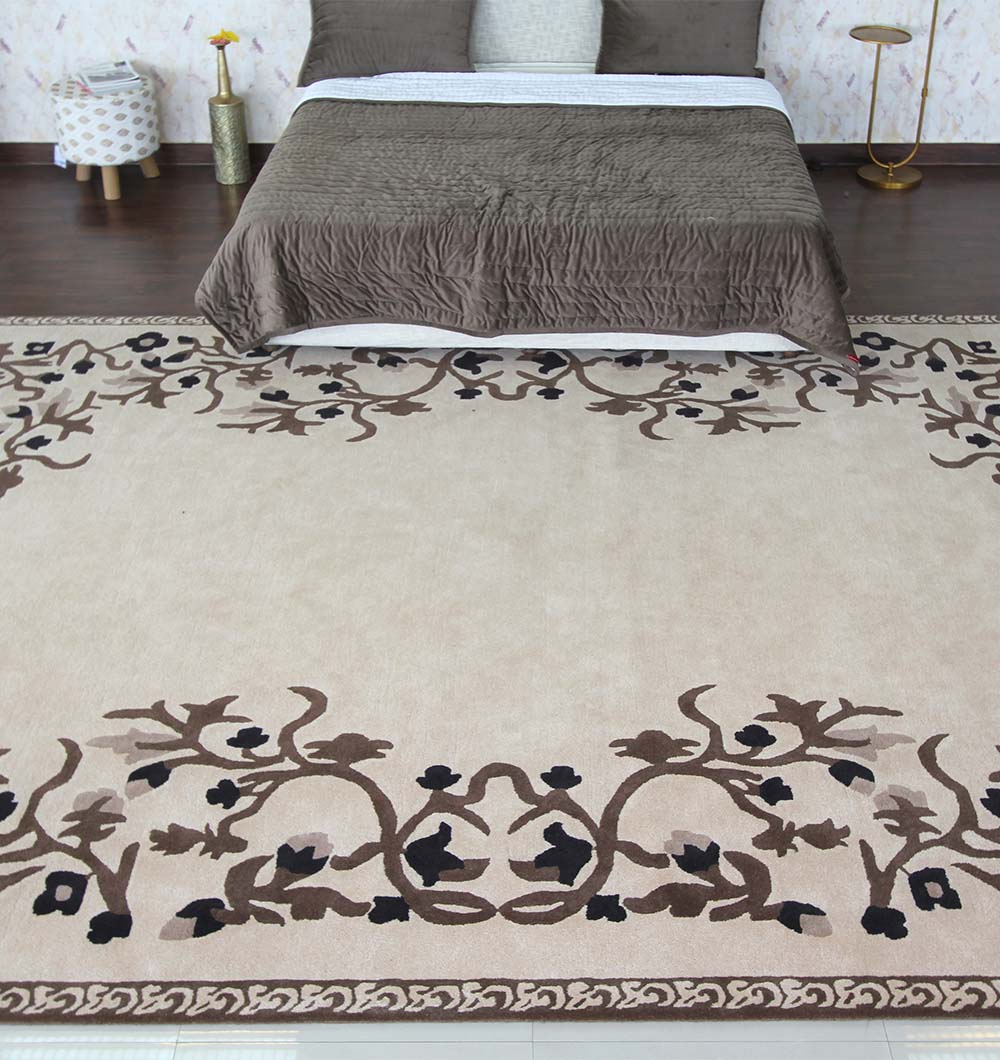 A RAMSHA HOME Multi Color Handmade Carpet 300X400 CM HTW-05 is placed in front of a neatly made bed with brown bedding in a modern bedroom featuring wooden flooring.