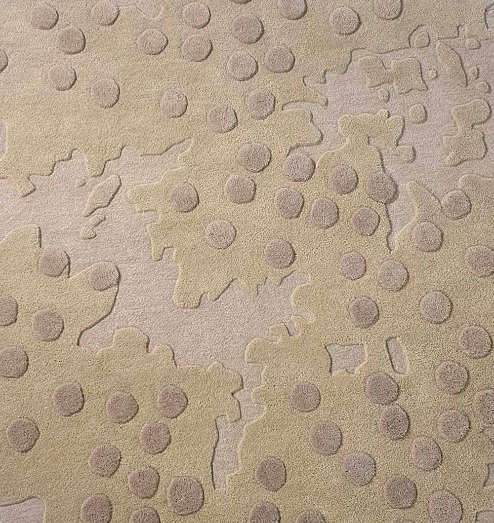 The RAMSHA HOME Round Home Decor Handmade Carpet – HTW-56 features a beige textured surface with raised, irregular shapes and scattered darker circular patterns. This hand-tufted rug offers a subtle, abstract design for any room.