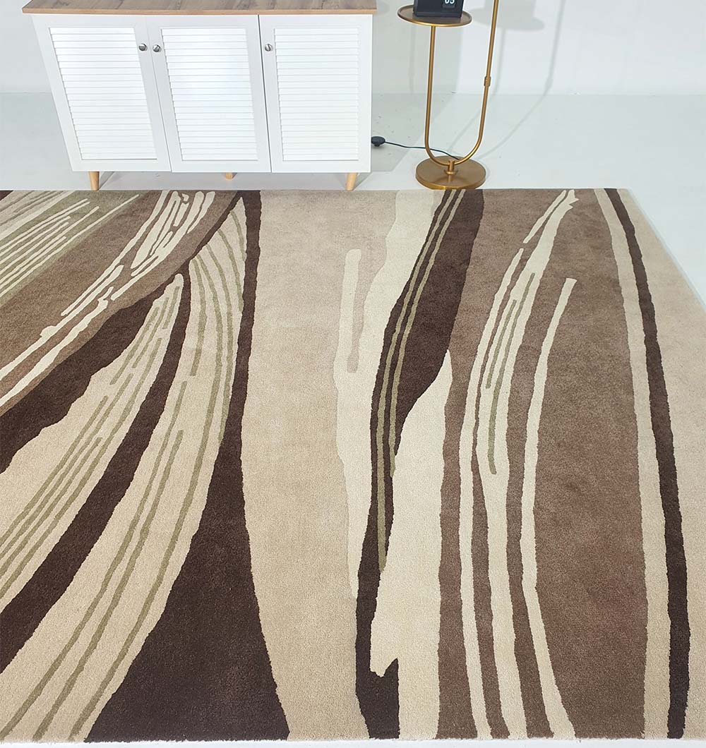 The RAMSHA HOME Striking Pattern Home Decor Handmade Carpet – HTW-61, a beige and brown wool blend with modern wavy designs, adds elegance to any room when placed near white cabinets and a gold floor lamp.
