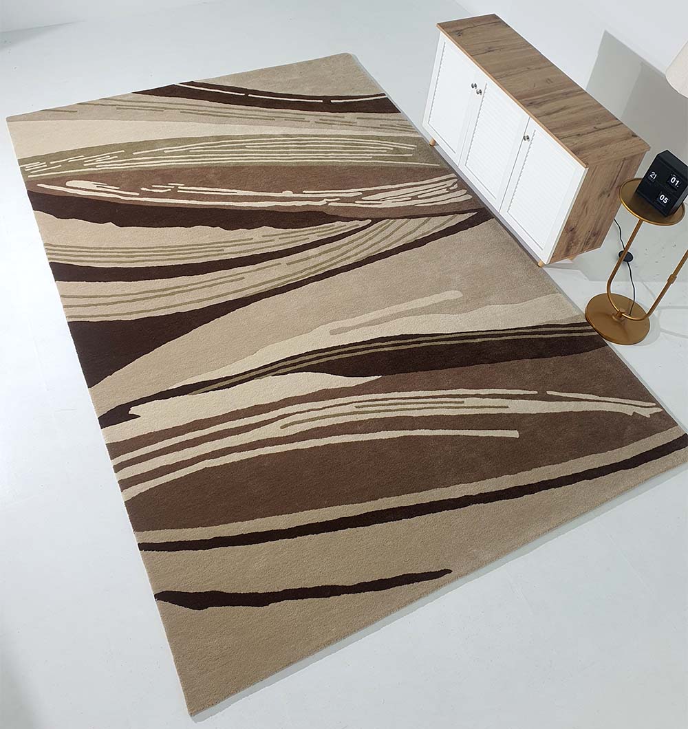 The Striking Pattern Home Decor Handmade Carpet – HTW-61 by RAMSHA HOME, featuring brown, beige, and cream wavy lines, lies on a white floor near a wooden cabinet and a gold side table with a black lamp.