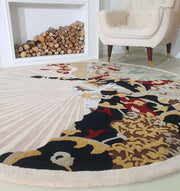 The RAMSHA HOME Round multi area rug 200 cm (HTW-73), a hand-tufted wool rug with a sunburst design, adds vibrant color near a white armchair and stacked firewood in the modern, minimalist living room.