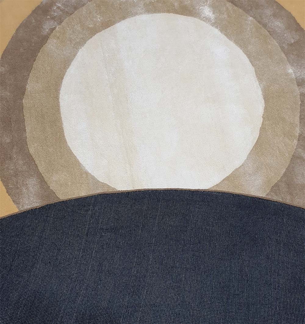 The Multi Color Handmade Hand Tufted Carpet HTWV-49 by RAMSHA HOME features abstract art with a large white circle and tan ring, reminiscent of the sun or moon, partially covered by a curved dark gray form on a brownish background.