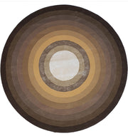 The RAMSHA HOME Multi Color Handmade Hand Tufted Carpet HTWV-49 is a round wool rug with concentric circles in brown, tan, and beige tones, creating a gradient from a light center to darker edges.