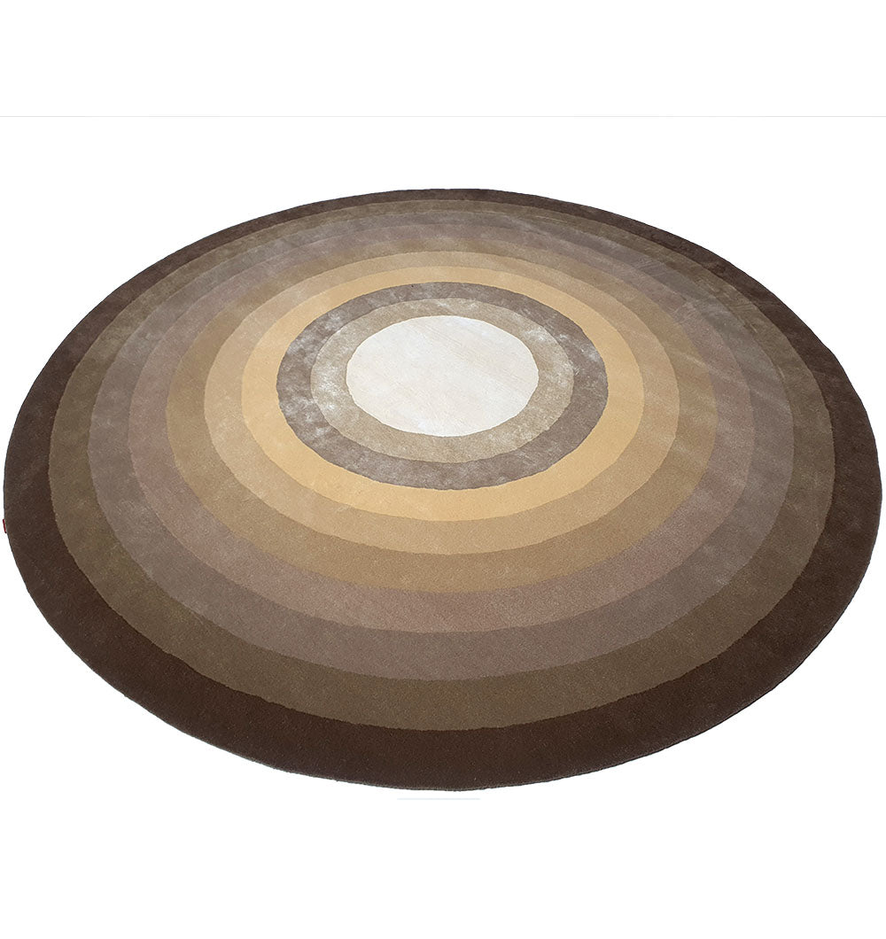 The RAMSHA HOME Multi Color Handmade Hand Tufted Carpet HTWV-49 features concentric circles in brown, beige, and tan shades, forming a gradient pattern. This round wool rug brings warmth and style to any space.