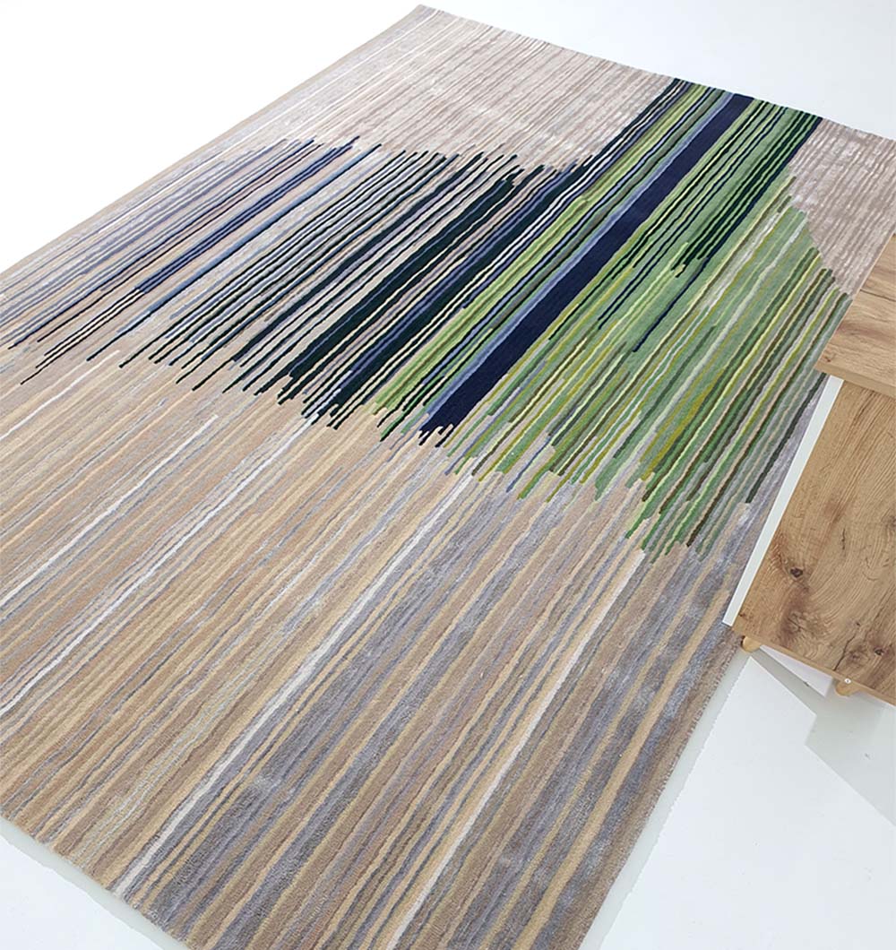 The RAMSHA HOME Striped, Beige & Grey Rug with Navy & Green Accent Bands – HTWV-52 features hand tufted wool blend construction and abstract colored lines, shown beside a wooden table on the right.