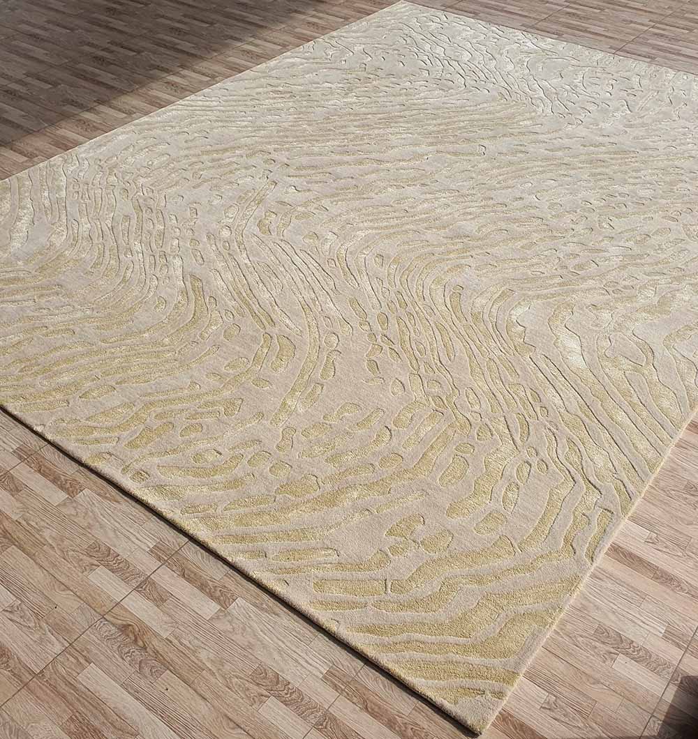 The RAMSHA HOME Handmade Multi Color Carpet For Home Decor HTWV-75, in beige with textured and wavy raised yellow patterns, is displayed on a light brown wood-patterned floor.
