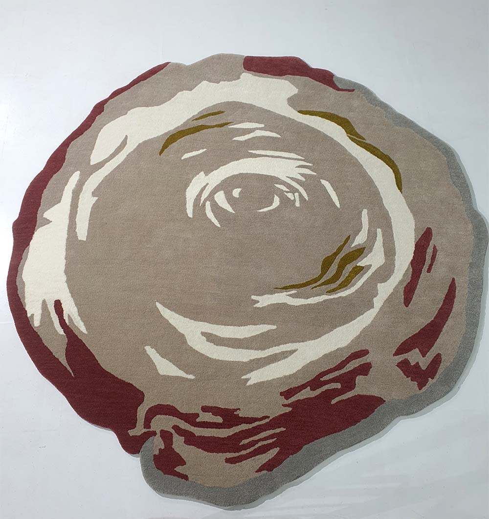 The RAMSHA HOME Handmade Multi Color Carpet HTW-60 is a hand-tufted, round rug with abstract swirling patterns in beige, cream, brown, and maroon on a light background, evoking tree rings or rose blossoms.
