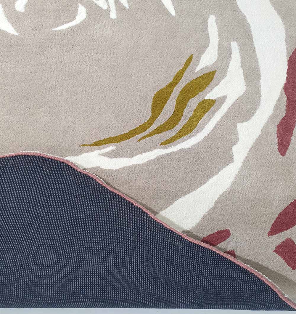 Close-up of the RAMSHA HOME Handmade Multi Color Carpet HTW-60, featuring abstract designs in beige, white, yellow, and red. A corner is flipped to reveal its dark grey textured backing.
