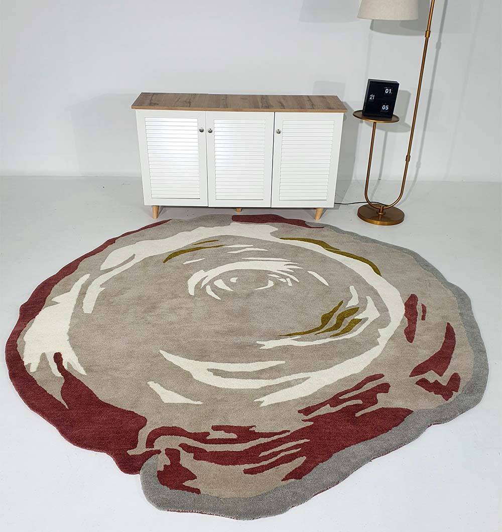 The RAMSHA HOME Handmade Multi Color Carpet HTW-60, featuring abstract patterns in beige, white, olive green, and maroon, is placed in front of a white cabinet with a wooden top. A gold floor lamp with a white shade stands nearby.