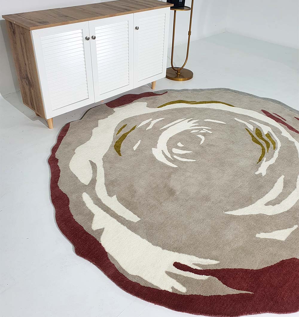 The RAMSHA HOME Handmade Multi Color Carpet HTW-60 features an abstract, floral-inspired design in beige, cream, olive, and burgundy tones. It adds a stylish touch to any modern space when placed on a white floor near minimalist furniture.