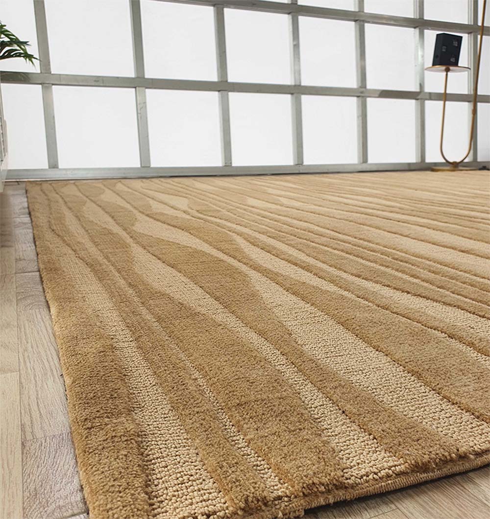 A close-up of the RAMSHA HOME Rectangle Beige Color Carpet MNR-03 with an abstract textured pattern on a light wood floor in a bright room with large frosted windows.