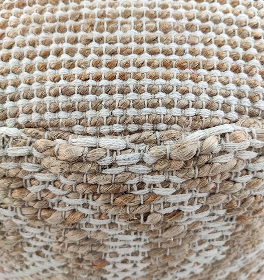 Close-up of the textured, grid-like weave of RAMSHA HOME’s Natural Jute Pouf With Leather Handle, featuring thick tan and beige fibers for an artisanal look.
