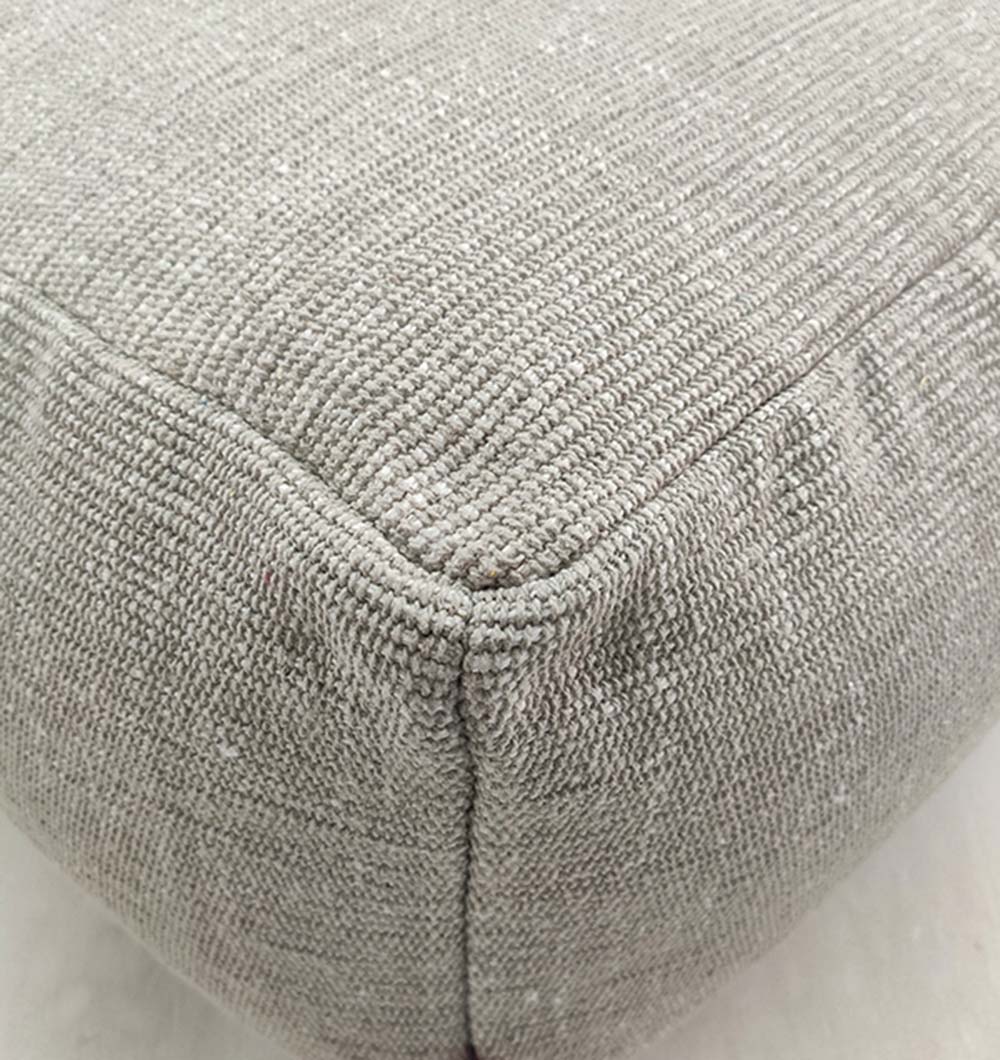 Close-up of the corner of RAMSHA HOME 100% Cotton Pouf PF-069, highlighting its beige textured fabric, detailed stitching, and woven material for breathable durability.