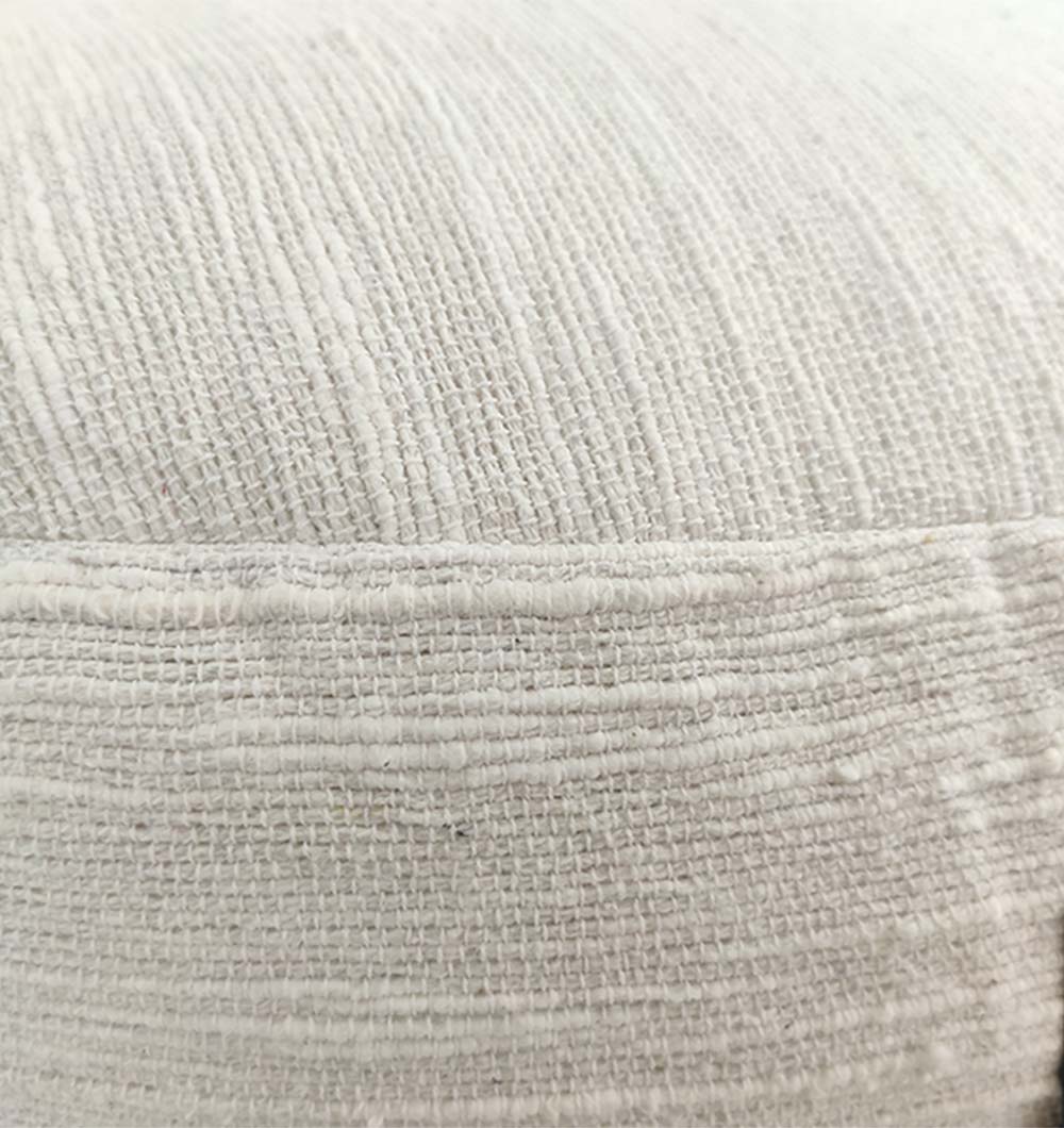 Handcrafted white pouf close-up showcasing soft cotton weave and cushion