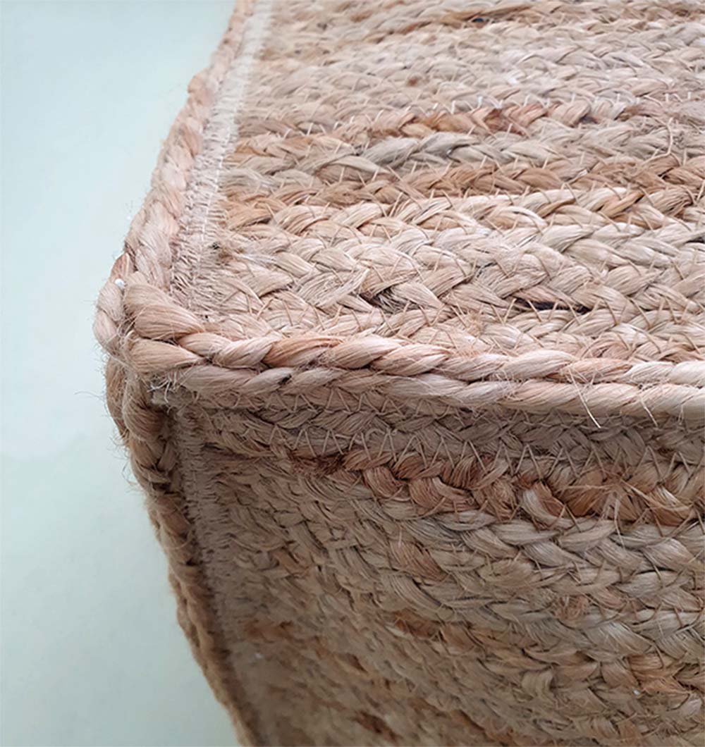 Close-up view of woven jute pouf showing detailed natural fiber texture and fine craftsmanship