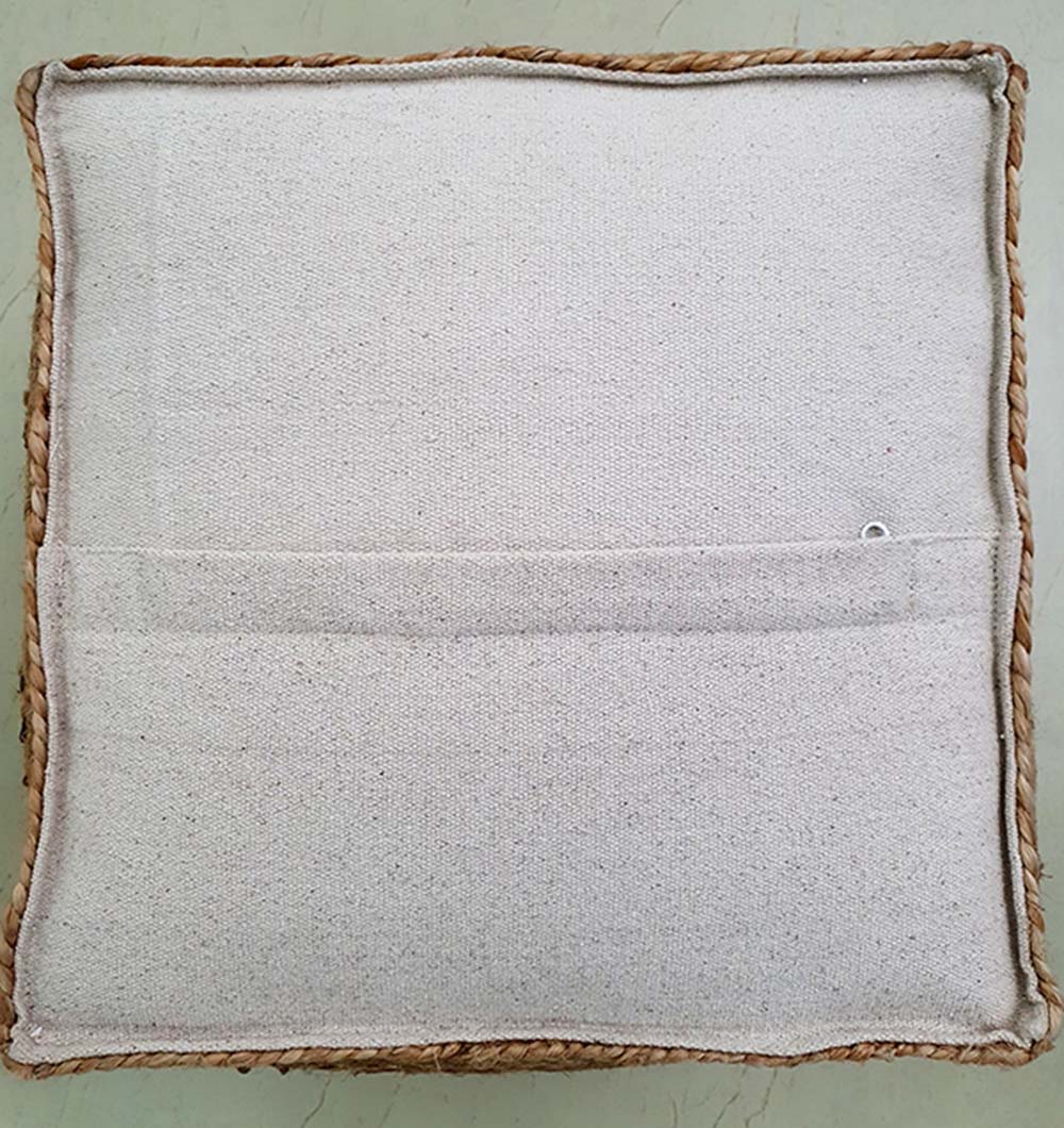 Backside view of woven jute pouf showing sturdy stitching and handcrafted detailing