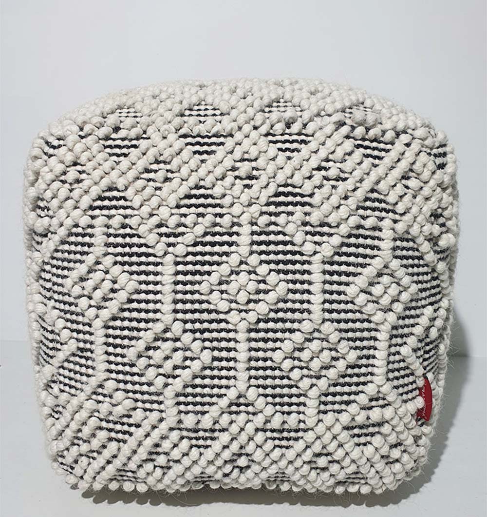 Natural toned cylinder pouf perfect as a footrest or stylish ottoman for home décor