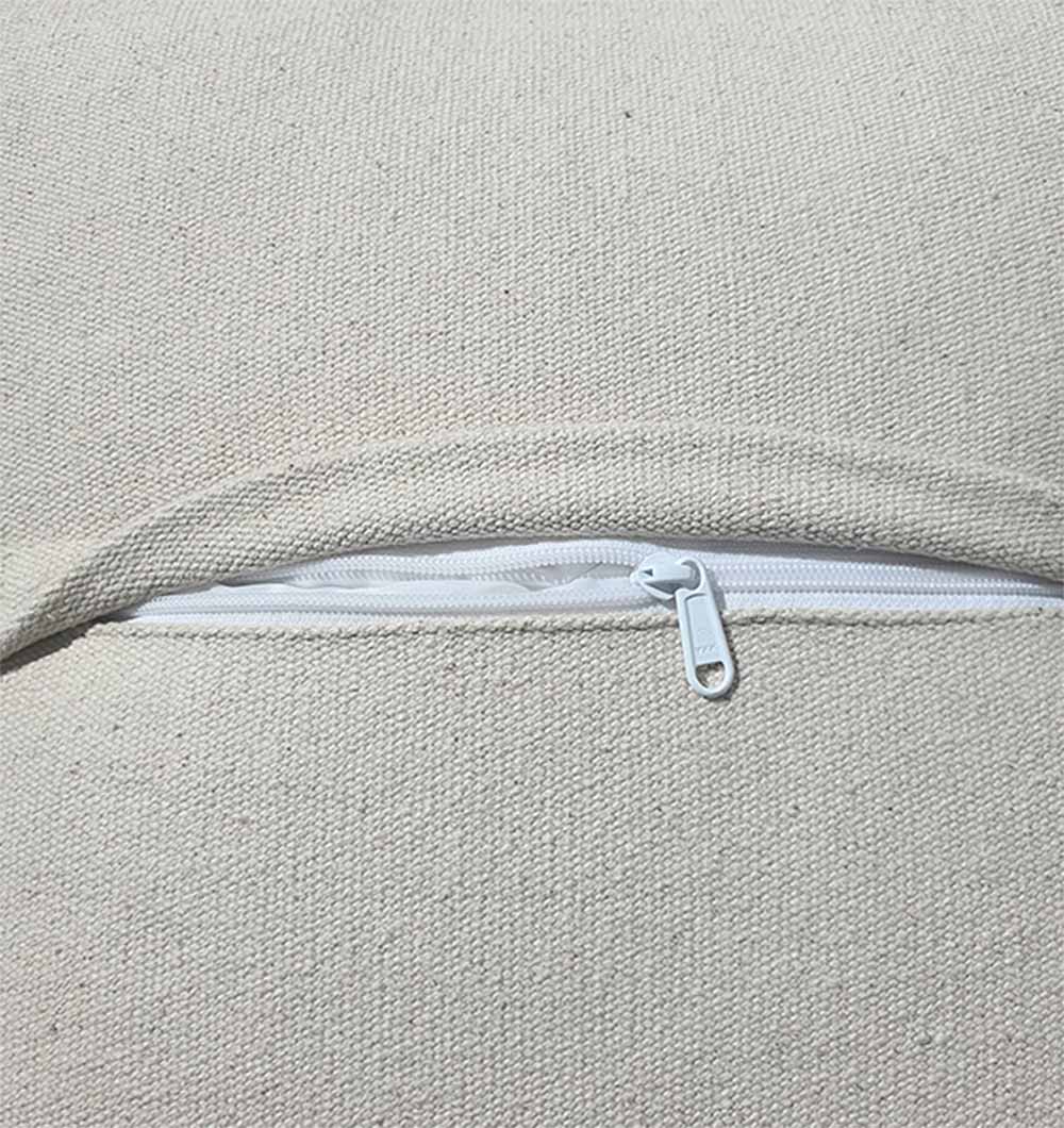 A close-up of a beige fabric cushion with a white zipper, showing the texture and pull tab—ideal for the RAMSHA HOME 100% Cotton Cover Pouf PF-145.