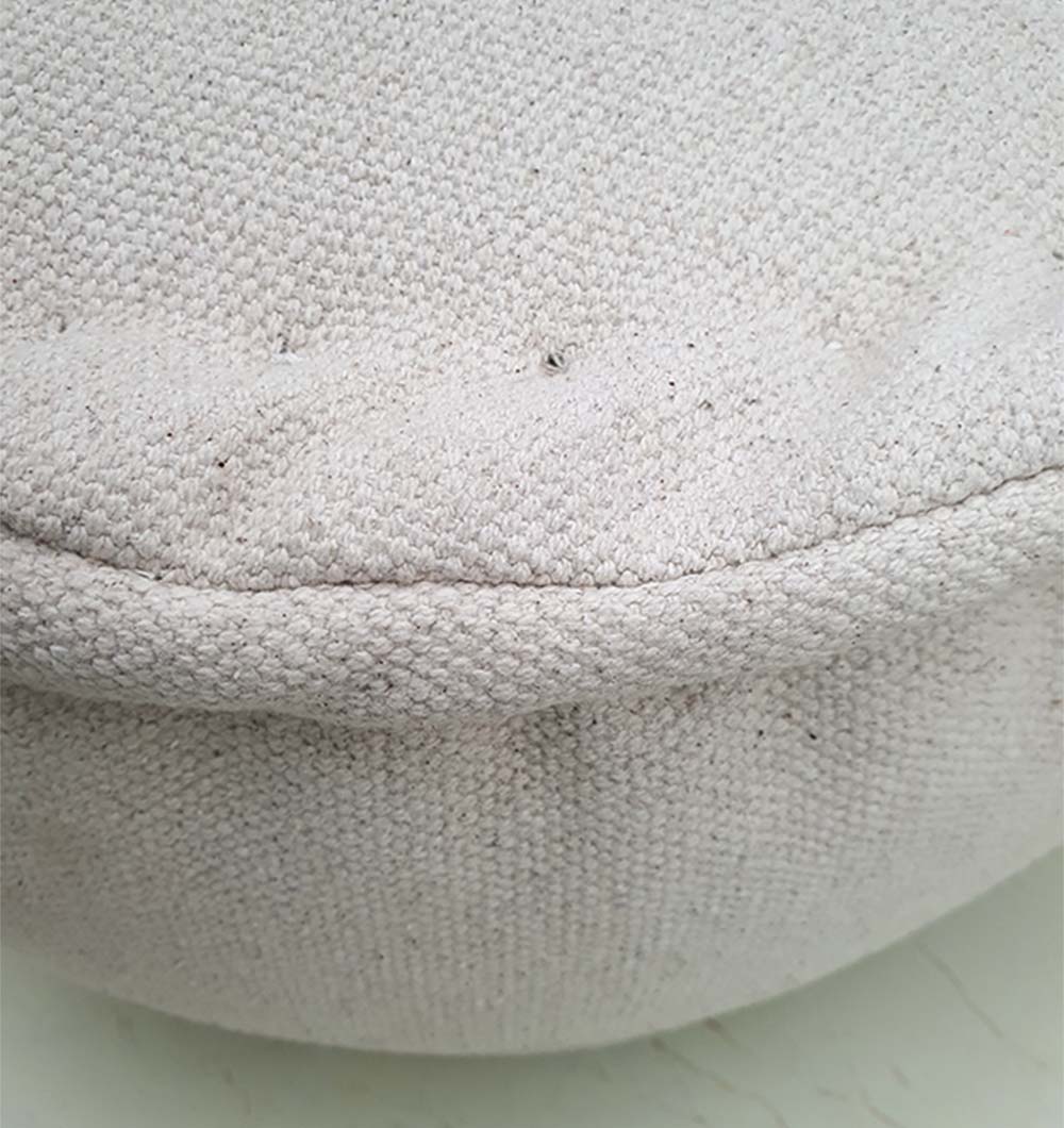 Detailed view of multi-colored handmade pouf highlighting polyester fabric weave